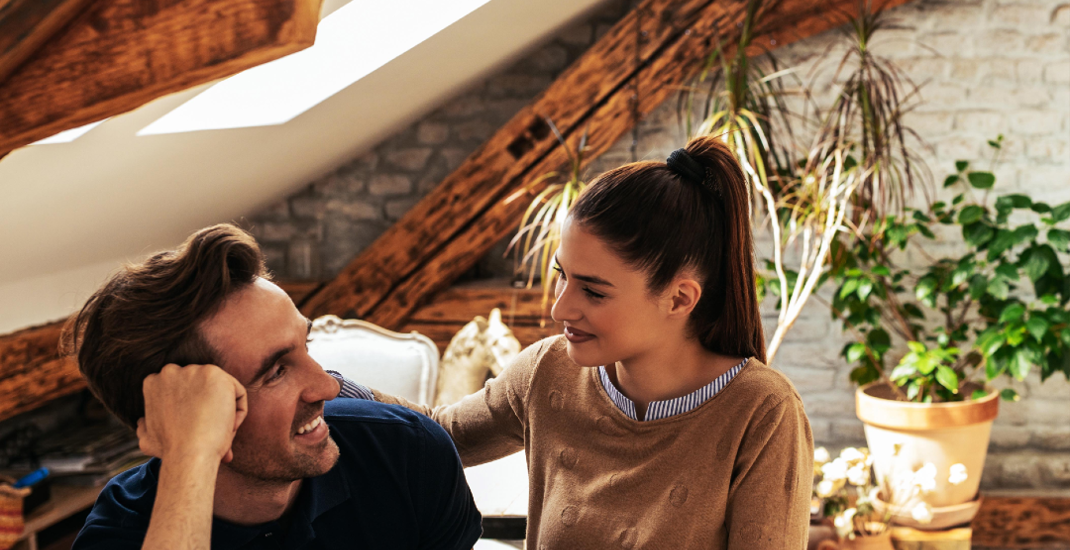 Couple looking at each other with laptop
